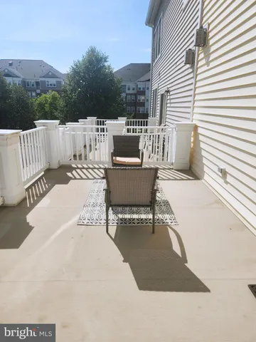 a view of a patio with a table and chairs and couches