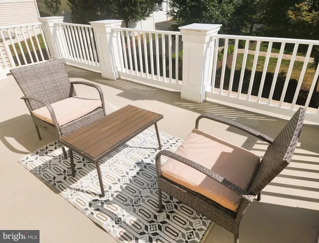 a view of a chair and table in the balcony