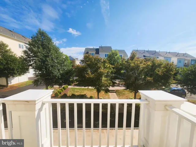 a view of a yard with wooden fence