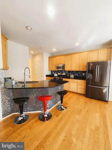 a kitchen with sink refrigerator and stove
