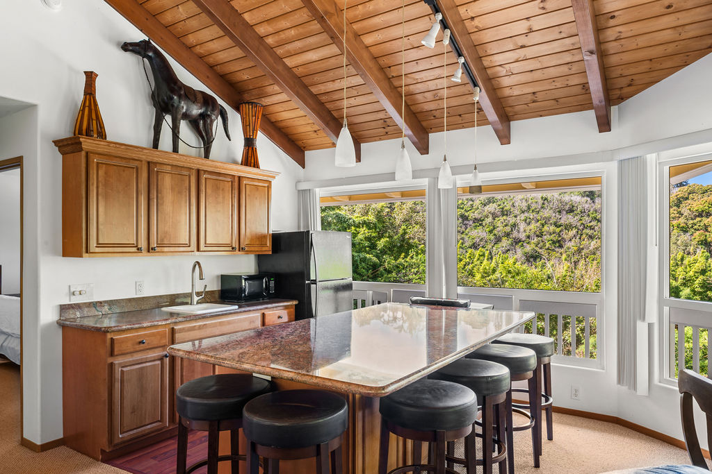 1444 East Kuiaha Road Haiku, HI 96708 - Photo 11 of 30 a kitchen with stainless steel appliances granite countertop a stove a refrigerator a sink a stove and white cabinets with wooden floor