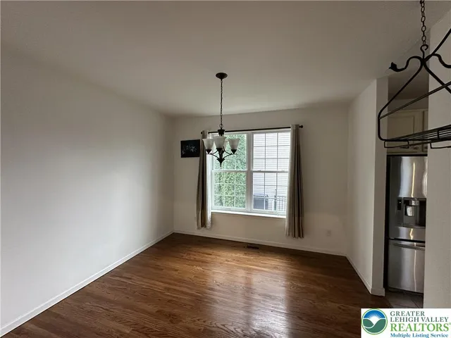 a kitchen with stainless steel appliances granite countertop a sink a stove top oven a counter space and cabinets