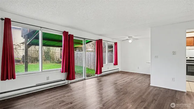 a view of empty room with wooden floor
