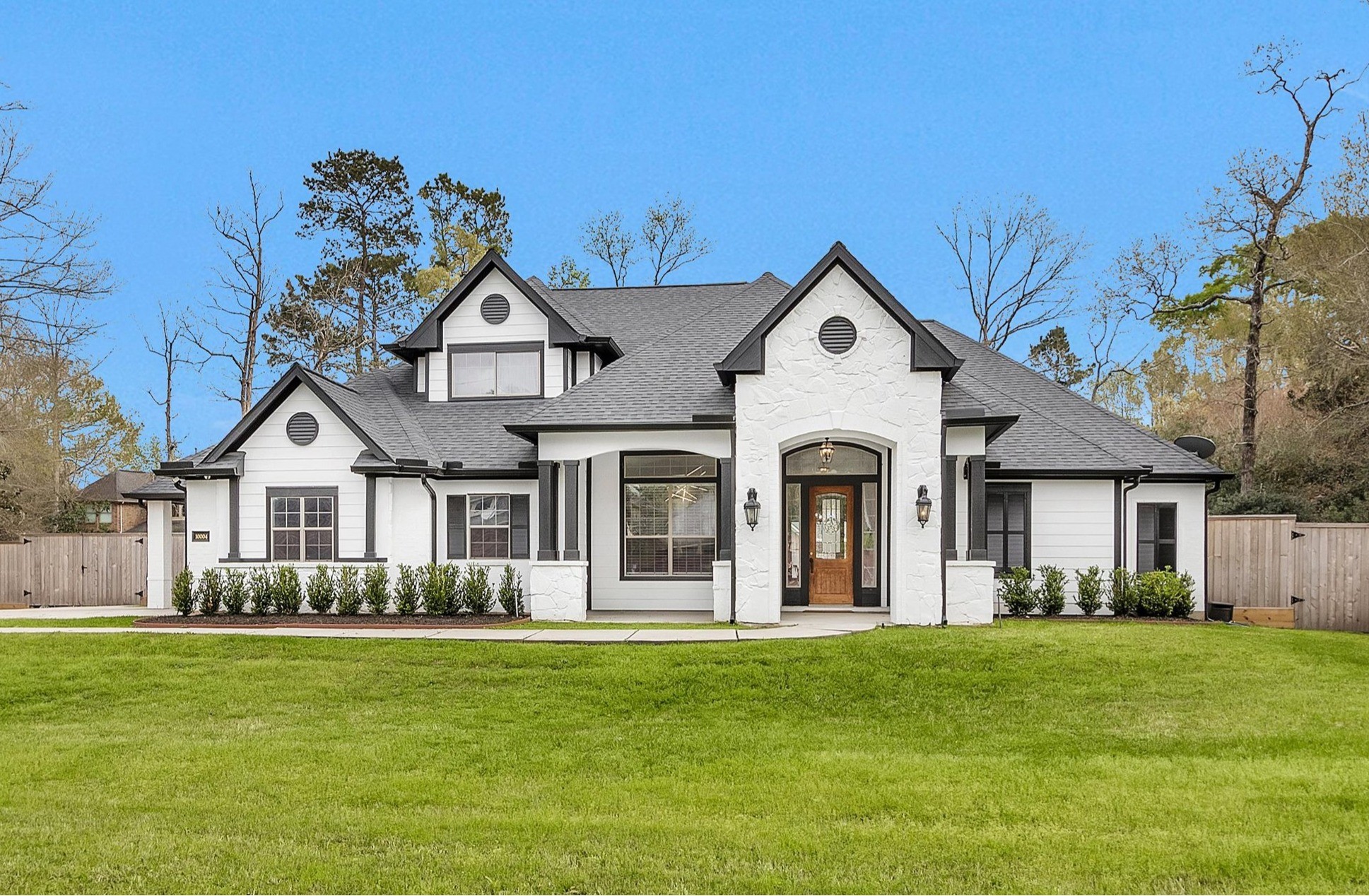 10004 Summer Ridge Lane Conroe, TX 77302 - Photo 2 of 50 a front view of a house with a garden