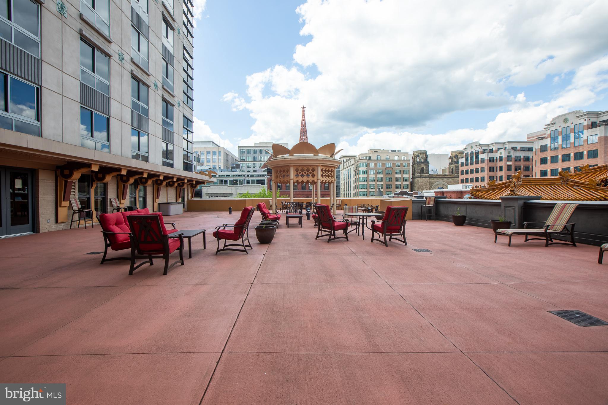 777 7th Street Northwest, Unit 1017 Washington, DC 20001 - Photo 4 of 13 a view of a patio with dining table and chairs