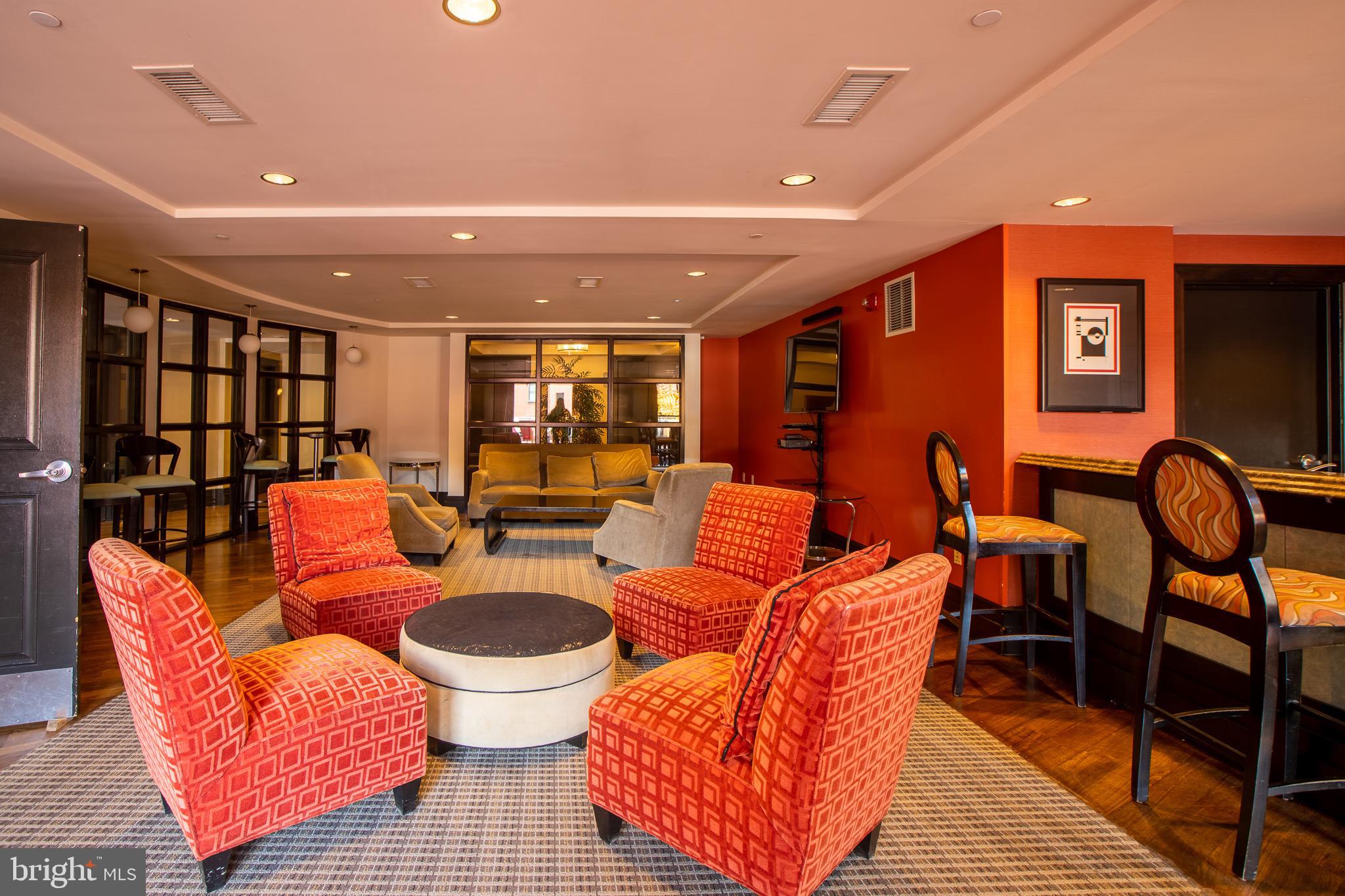 777 7th Street Northwest, Unit 1017 Washington, DC 20001 - Photo 6 of 13 a living room with furniture a rug and a chandelier