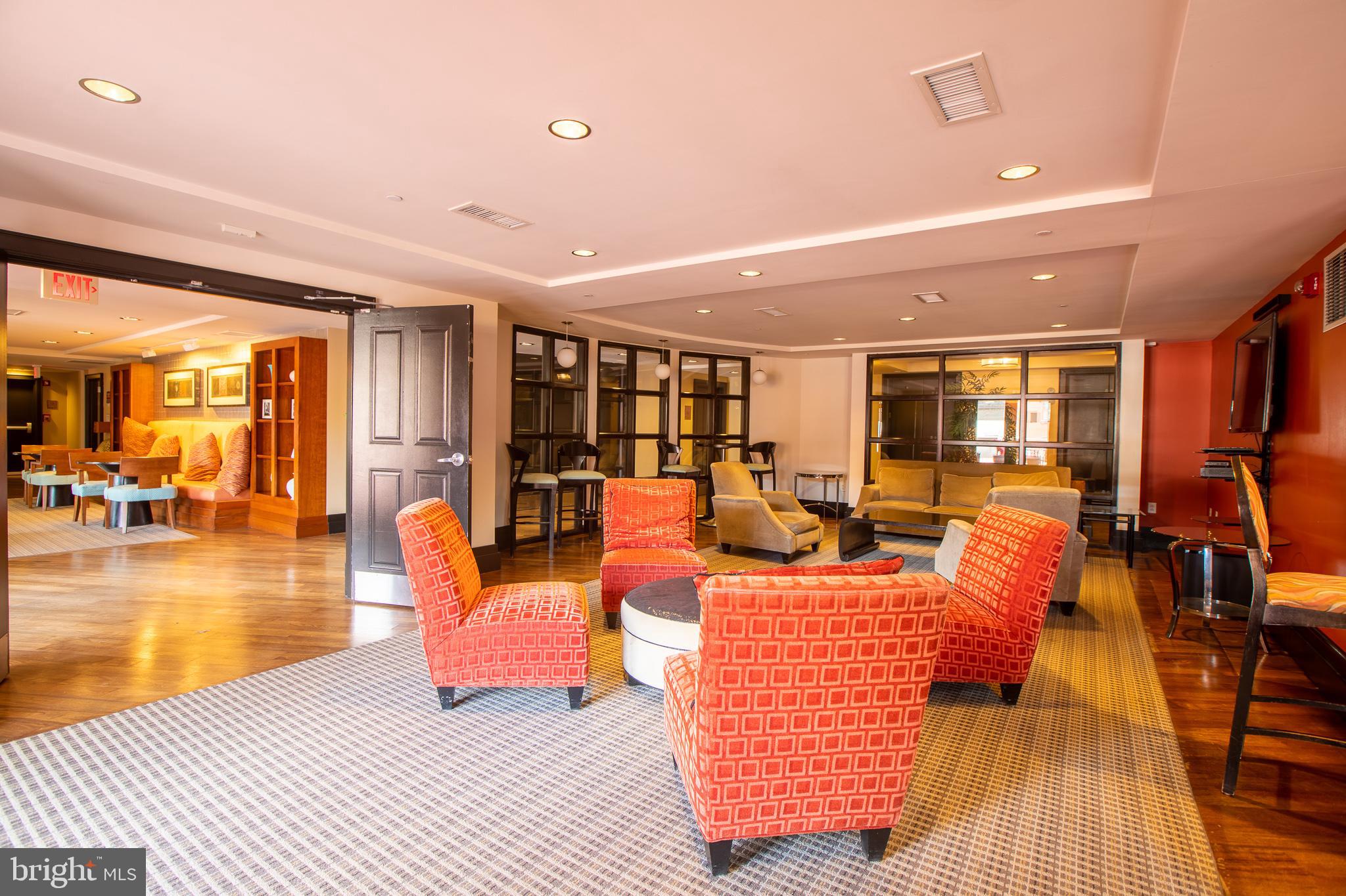 777 7th Street Northwest, Unit 1017 Washington, DC 20001 - Photo 7 of 13 a living room with furniture and a dining table with wooden floor