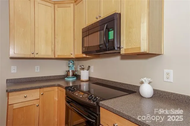 a kitchen with stainless steel appliances granite countertop a sink and a stove