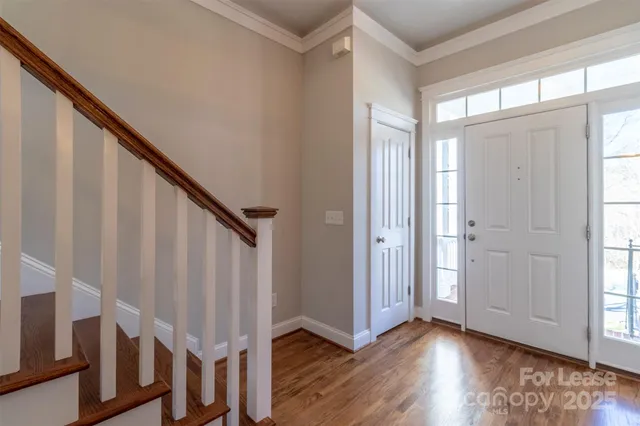 a view of entryway with wooden floor and stairs