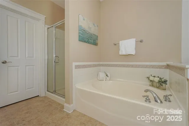 a spacious bathroom with a bathtub and shower