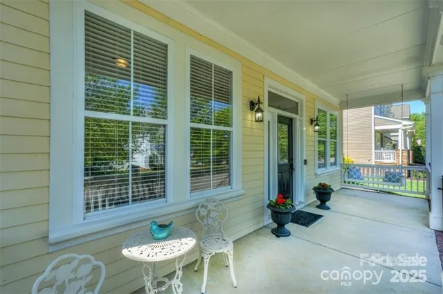 a view of two chairs in the patio