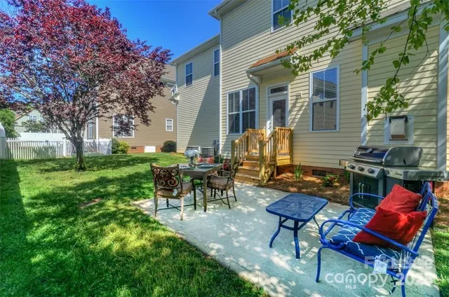 a view of a chairs and table in backyard of the house