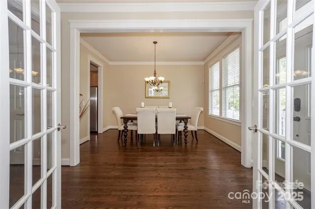 a view of a a dining room with furniture window and wooden floor
