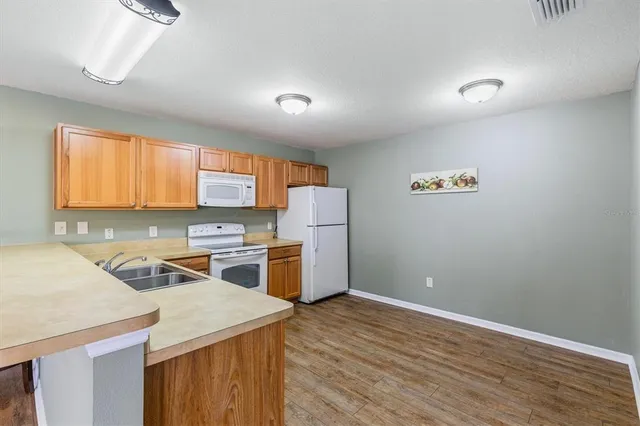 a kitchen that has a cabinets and a stove in it