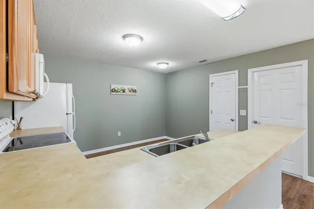 a view of a kitchen with furniture and staircase