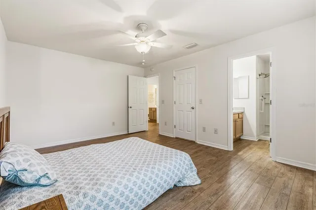 a bedroom with a bed and a chandelier