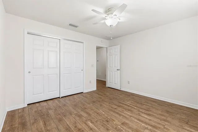 a view of an empty room with a fan