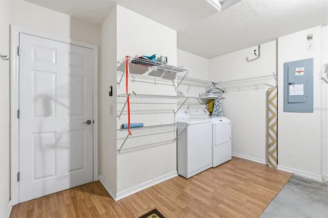 a utility room with cabinets washer and dryer