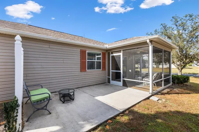 a view of a chairs and table in backyard of the house