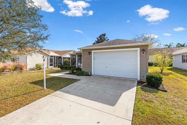 a view of a house with a yard and garage