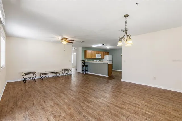 a view of a room with a sink and wooden floor