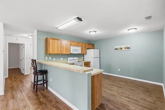 a view of a kitchen with wooden floor