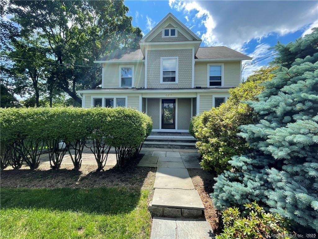 490 Riverside Avenue, Unit 4 Westport, CT 06880 - Photo 1 of 1 a front view of a house with a yard