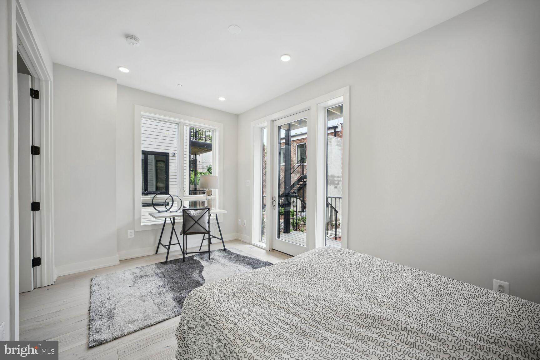 1744 Lanier Place Northwest, Unit 1 Washington, DC 20009 - Photo 13 of 39 a spacious bedroom with a bed and a table