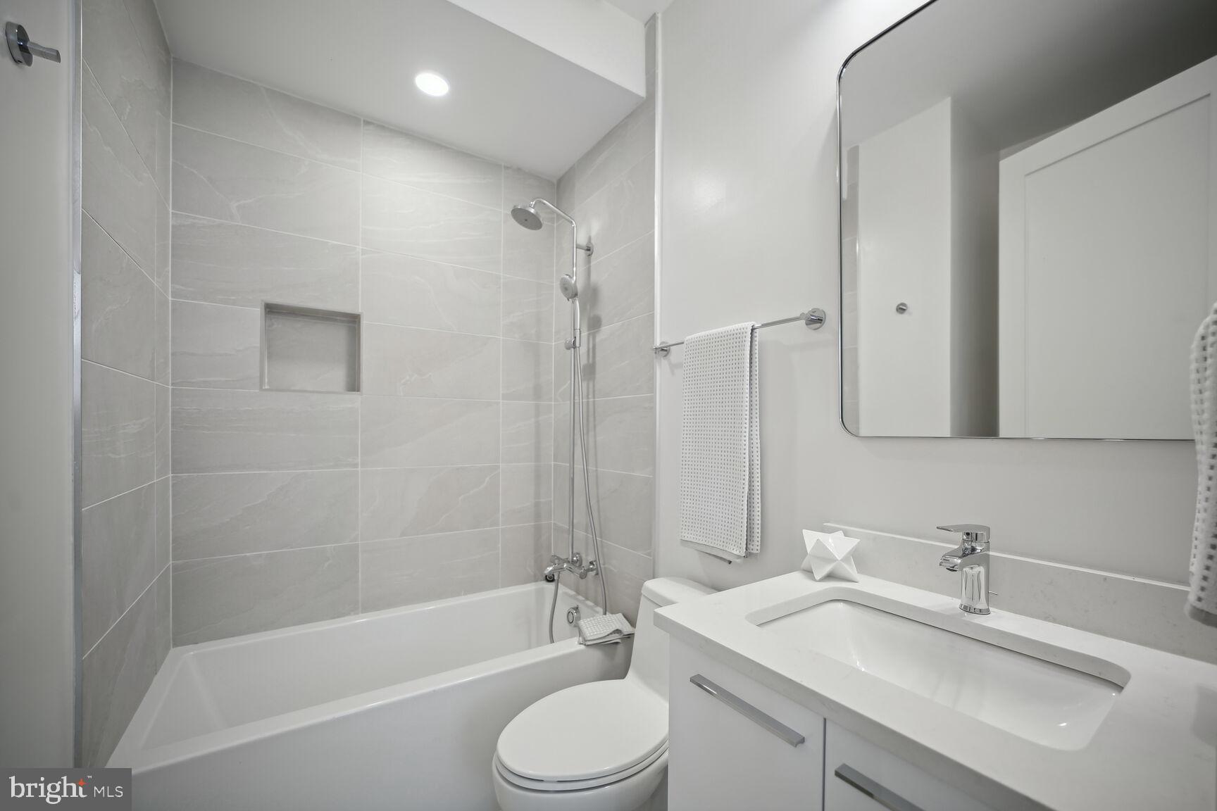 1744 Lanier Place Northwest, Unit 1 Washington, DC 20009 - Photo 18 of 39 a bathroom with a granite countertop sink toilet and shower
