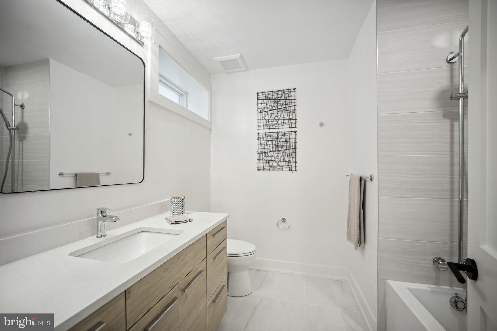1744 Lanier Place Northwest, Unit 1 Washington, DC 20009 - Photo 20 of 39 a bathroom with a sink a toilet and shower