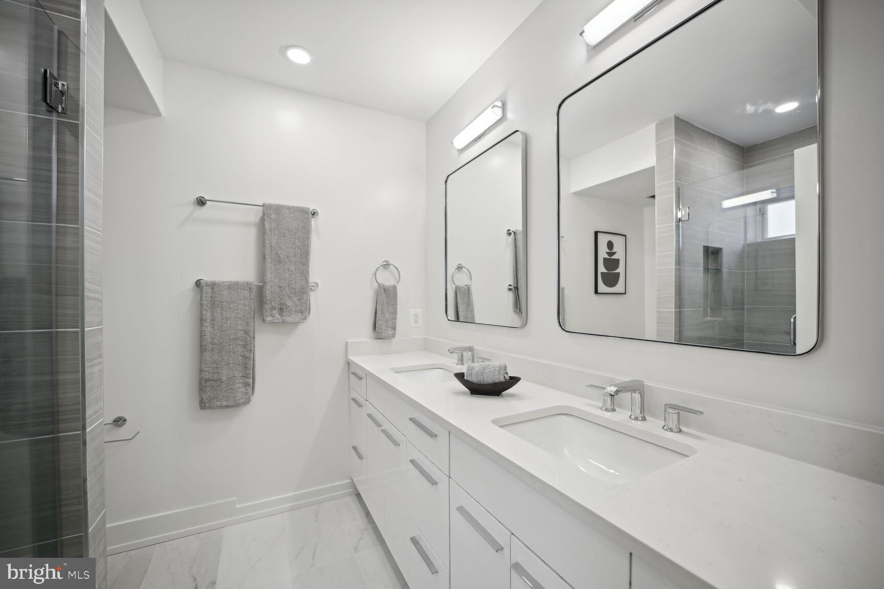 1744 Lanier Place Northwest, Unit 1 Washington, DC 20009 - Photo 22 of 39 a bathroom with double vanity sink a mirror and shower