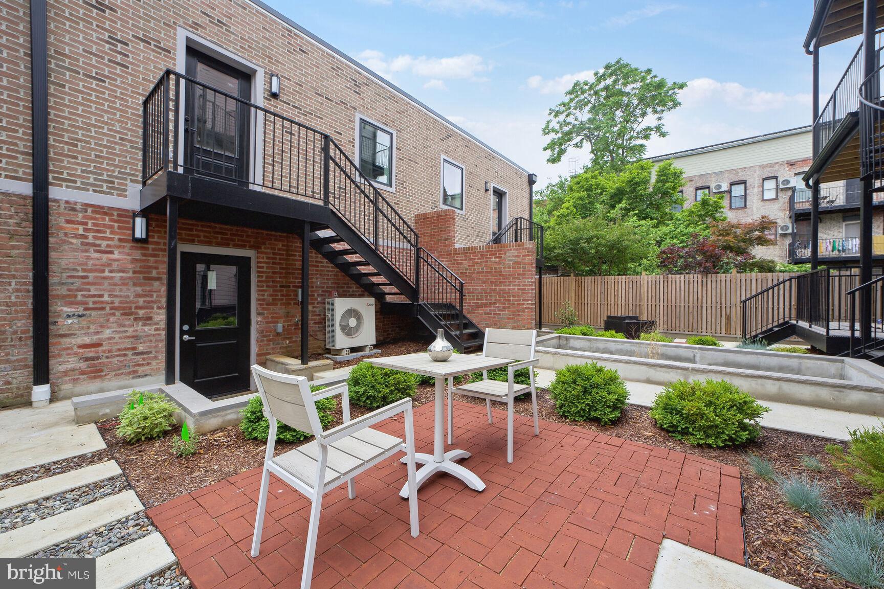 1744 Lanier Place Northwest, Unit 1 Washington, DC 20009 - Photo 27 of 39 a view of a chair and table in backyard
