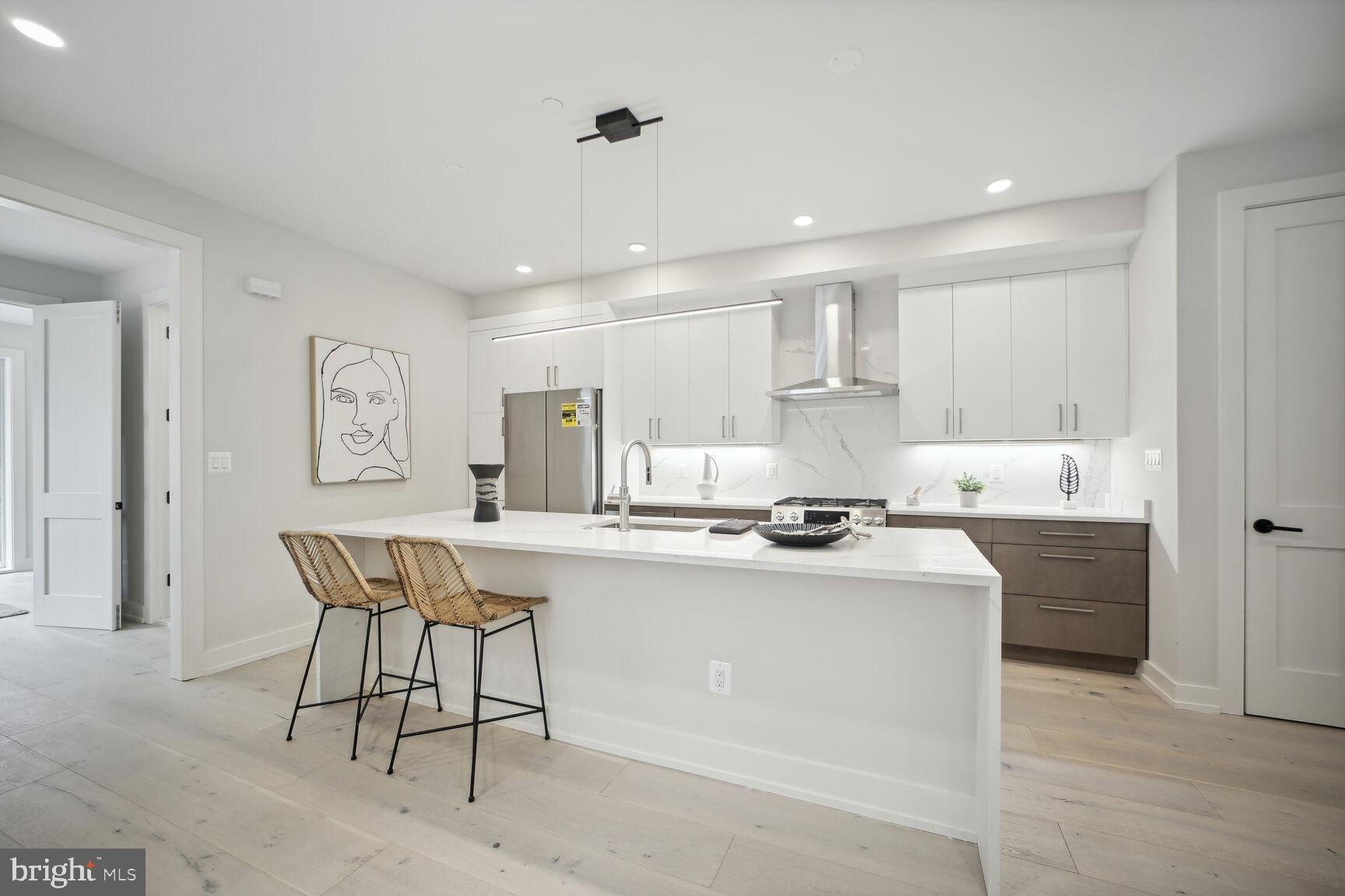 1744 Lanier Place Northwest, Unit 1 Washington, DC 20009 - Photo 10 of 39 a kitchen with stainless steel appliances granite countertop a sink and a refrigerator