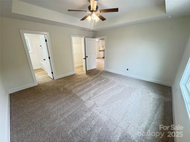 an empty room with fan and entrance