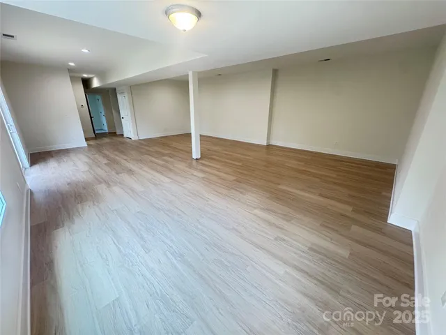 a view of a backyard with plants and trees