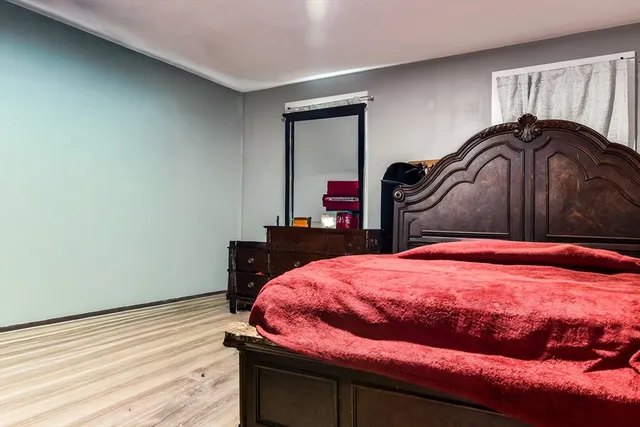 a bedroom with a bed and a mirror