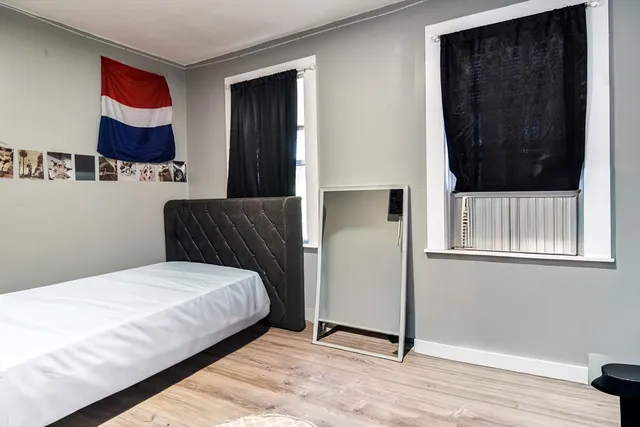 a bedroom with a bed and a window