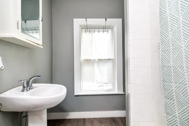 a bathroom with a sink and a window