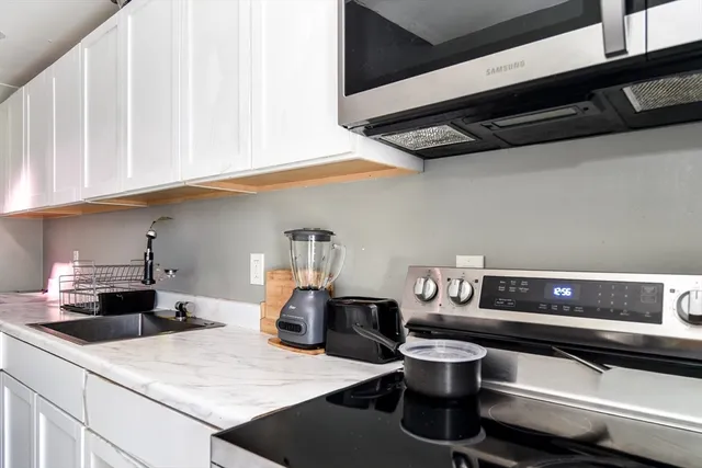 a kitchen with a sink and cabinets