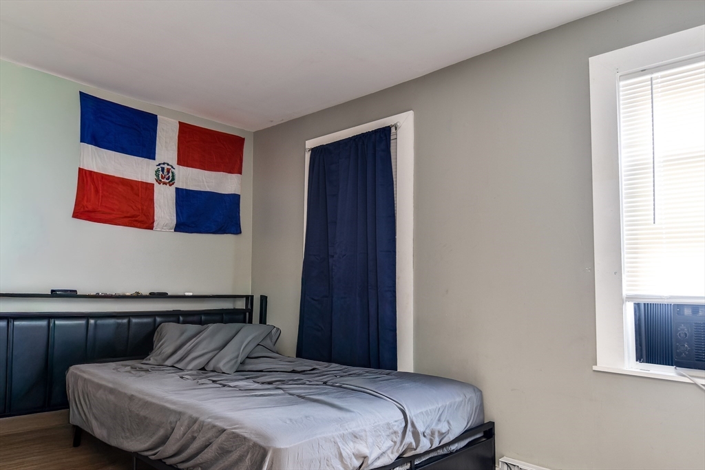 136 Commonwealth Road Wayland, MA 01778 - Photo 6 of 15 a bedroom with a bed and wooden floor