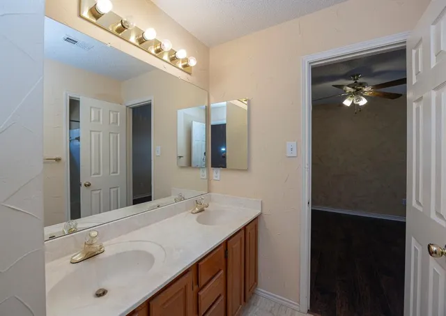 a bathroom with a double vanity sink and a mirror