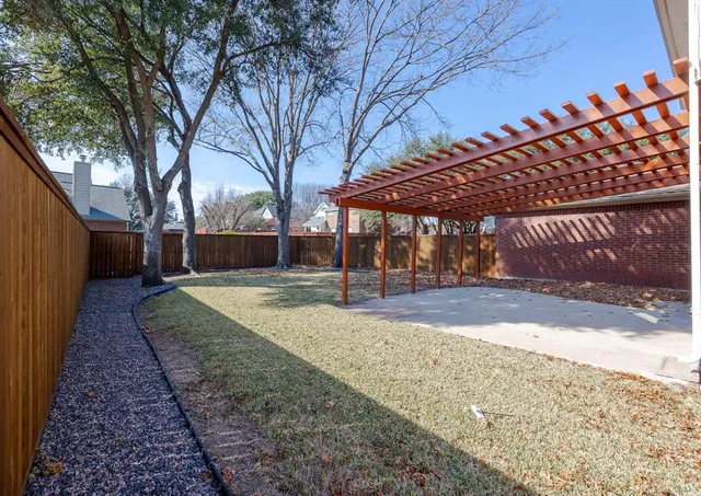 a view of a backyard with large trees