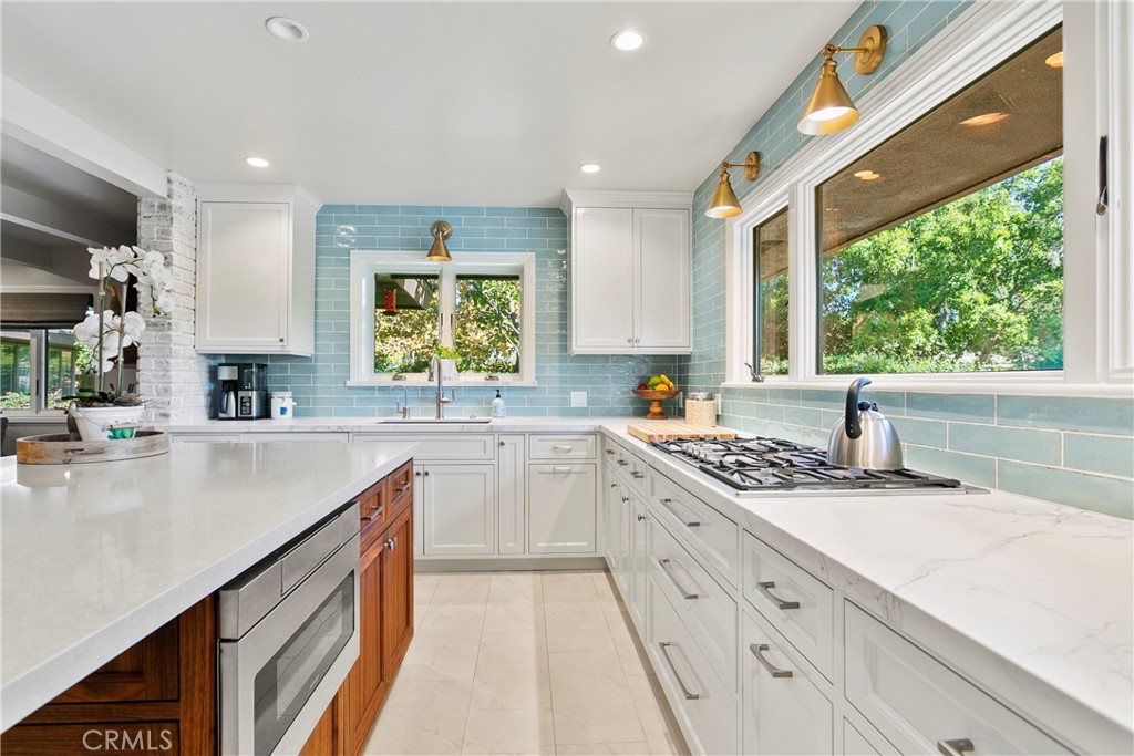 3305 Rancho Rio Bonita Road Covina, CA 91724 - Photo 17 of 71 Your convenient under counter microwave sits in your walnut cabinet under your quartz counter top. Wrap around counter to ceiling subway tile. Note that there are no obstructions of the light and view.