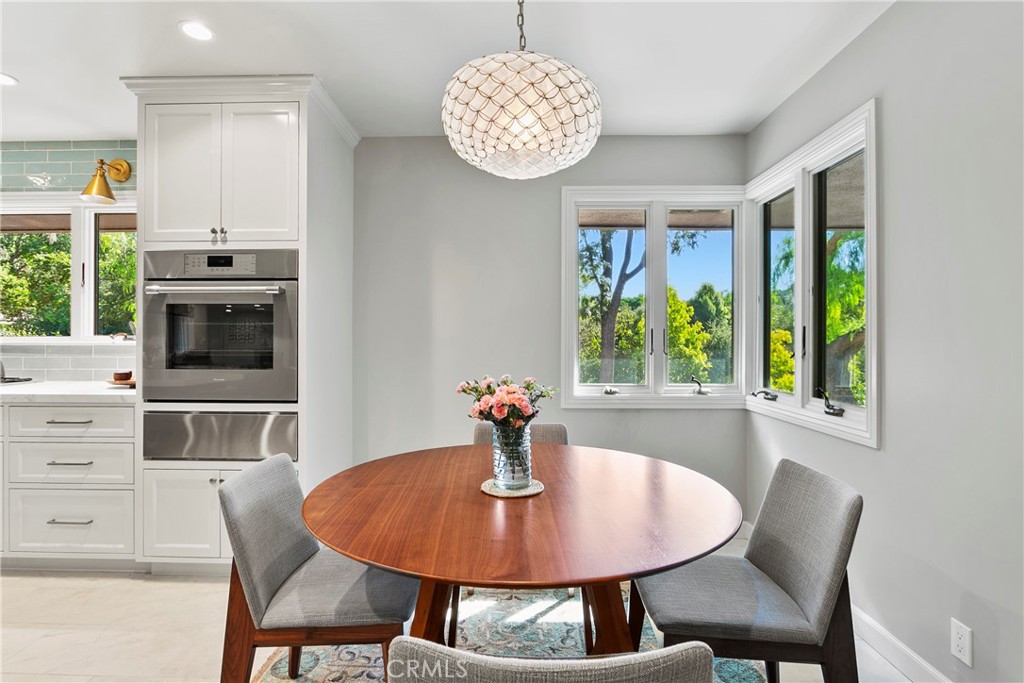 3305 Rancho Rio Bonita Road Covina, CA 91724 - Photo 20 of 71 a dining room with furniture a window and a chandelier