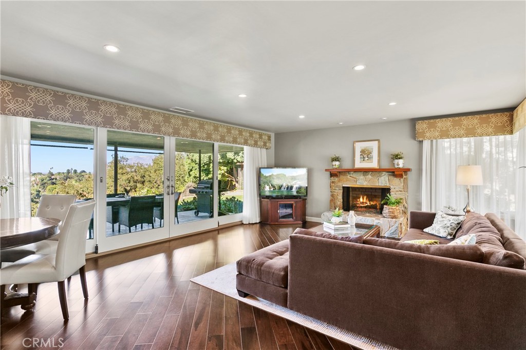 3305 Rancho Rio Bonita Road Covina, CA 91724 - Photo 22 of 71 a living room with furniture a fireplace and a floor to ceiling window