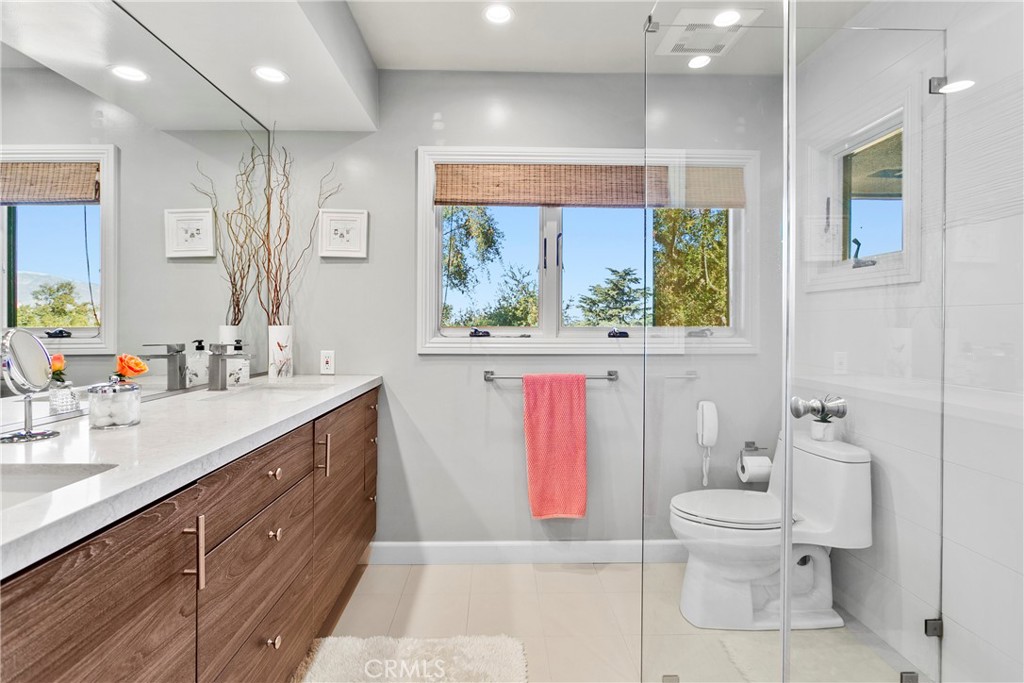3305 Rancho Rio Bonita Road Covina, CA 91724 - Photo 32 of 71 a spacious bathroom with a granite countertop toilet a sink and a large mirror