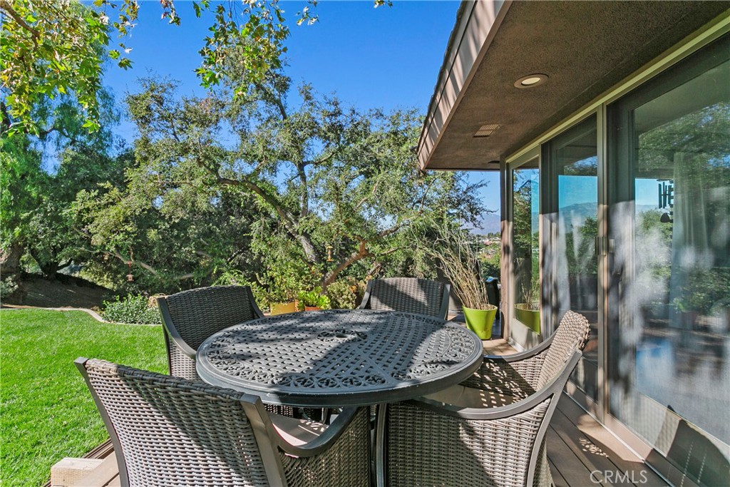 3305 Rancho Rio Bonita Road Covina, CA 91724 - Photo 62 of 71 a roof deck with a table and chairs and potted plants
