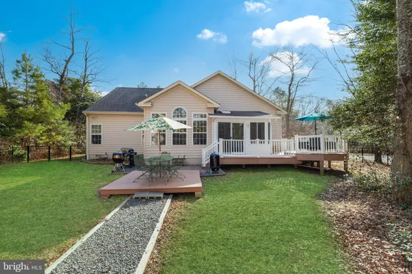 a view of a house with a yard porch and sitting area