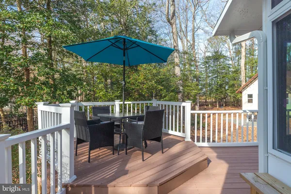 a view of a balcony with wooden floor and umbrella