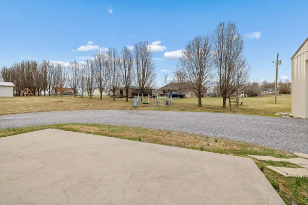a view of a swimming pool and a yard